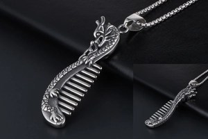 Macro view of retro silver dragon comb pendant with intricate scales and steel mesh chain