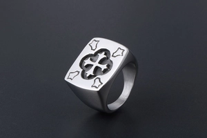 Close-up of vintage stainless steel signet ring with embossed cross design for men