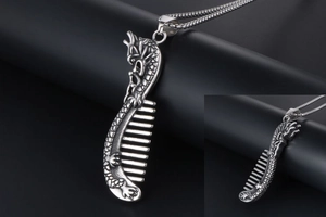 Detailed close-up of retro dragon pattern on a comb-shaped stainless steel pendant
