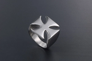 Detailed macro view of the polished silver Maltese Cross on the smooth metal biker ring