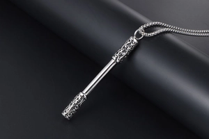 Macro detail of the Sun Wukong golden hoop staff pendant with ornate cloud pattern engraving