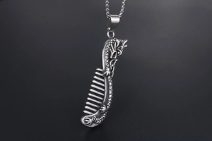 Macro detail of retro dragon comb pendant with antique silver finish and steel texture