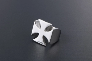 Macro shot of polished silver stainless steel ring with hollowed cross design details