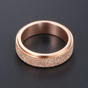 Rose gold spinner ring with frosted sand finish and brushed stainless steel design