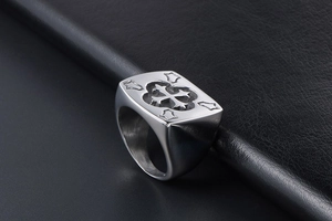 Close-up of vintage titanium steel ring featuring an engraved cross seal design