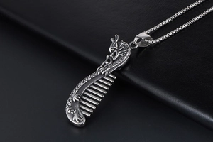 Detailed close-up of retro titanium steel comb pendant with intricate dragon relief