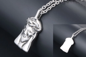 Macro detail of silver Jesus portrait pendant with crown of thorns and polished back