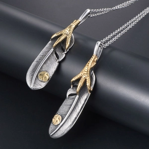 Vintage eagle claw feather pendant necklace in antique silver with gold tribal accents