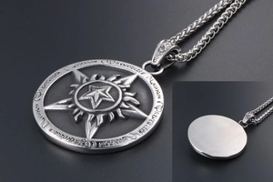 Detailed macro view of vintage star pendant with intricate flame patterns and engravings