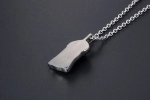 Detail view of the brushed silver titanium steel pendant with a vintage punk texture
