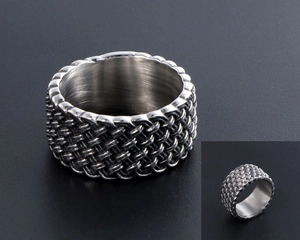 Macro shot of retro braided woven pattern on vintage titanium steel men's ring
