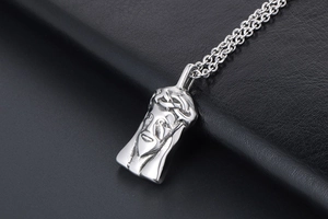 Close-up of titanium steel Jesus pendant with detailed crown of thorns on black leather