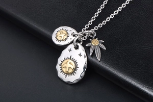Detail of vintage eagle and maple leaf pendants with gold accents on black leather
