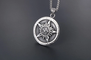 Macro view of vintage titanium steel pentagram pendant with rune edge and flame engraving