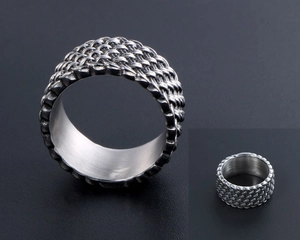Macro detail of punk style braided titanium steel ring with industrial weave texture