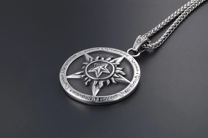 Macro shot of vintage titanium steel star pendant with embossed flame and rune details
