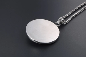 Detail view of the brushed metal back and decorative vintage clasp of the star pendant