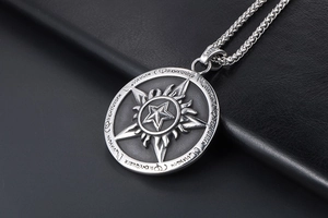 Macro shot of vintage titanium steel pentagram pendant with flame details and mystic runes