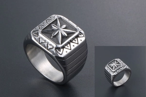 Detailed macro view of vintage punk signet ring with engraved star pattern and matte finish