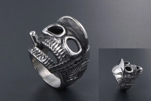 Macro shot of retro skull ring with hat and cigarette detail in silver steel