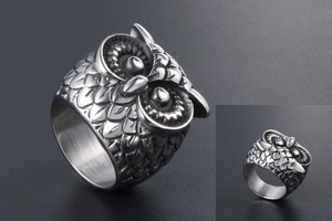 Close-up of vintage owl ring showing detailed feather texture and polished inner band