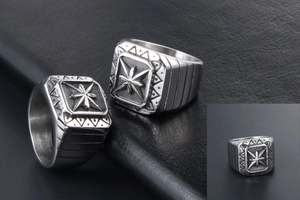 Macro shot of silver signet ring with engraved star pattern and retro punk metal textures