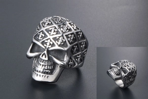 Detailed macro view of retro skull ring featuring rhombus pattern and floral relief carvings