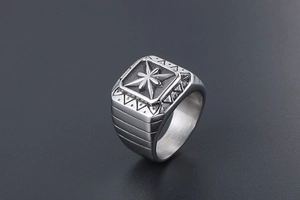 Macro shot of vintage silver signet ring with engraved star and punk geometric patterns