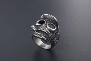 Detailed close-up of retro gothic skull ring with hat and cigarette in stainless steel