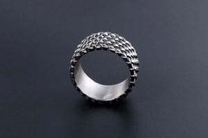Macro shot of retro braided titanium steel ring with vintage silver finish and wide band