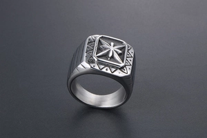 Detail of vintage signet ring featuring square compass engraving and geometric patterns