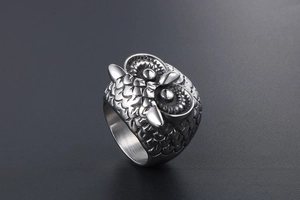 Macro shot of retro owl ring showing intricate feather textures and high relief details