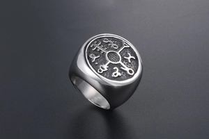 Detailed macro view of silver Viking compass ring with vintage hammered metal texture