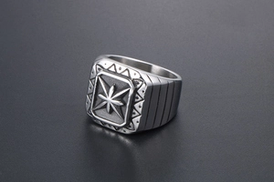 Macro shot of retro steel signet ring with engraved star pattern and matte finish