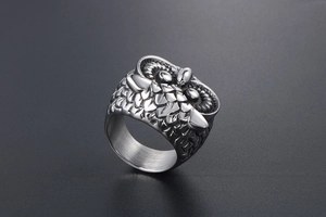Close-up of vintage owl ring detail showing textured feathers and gothic steel finish