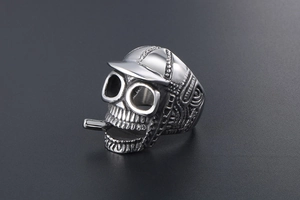 Detailed macro view of vintage punk skull ring wearing a hat and smoking a cigarette