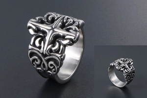Detailed close-up of gothic cross ring featuring vintage scrollwork and hollow patterns
