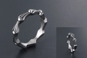 Macro shot of silver gothic skeleton bone link ring with polished titanium steel finish