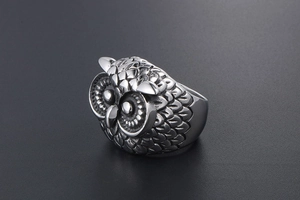 Detailed macro view of retro stainless steel owl ring with intricate feather texture