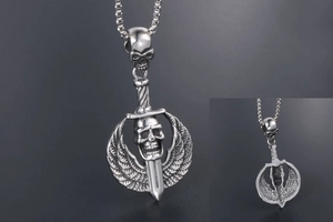 Macro detail of punk skull sword pendant with gothic wings in silver stainless steel
