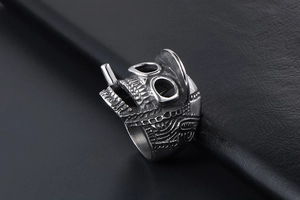 Macro detail of gothic skull ring with hat showing vintage silver finish and texture