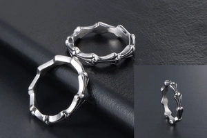 Close-up of retro silver stainless steel ring with gothic cross and floral relief