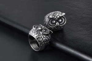 Macro shot of two vintage owl rings with detailed feathers and a punk style silver finish