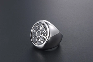 Detailed close-up of retro silver signet ring with engraved mystical symbols