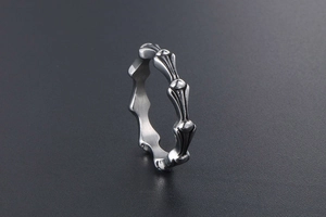 Detailed view of vintage titanium steel ring with textured cross pattern and oxidized finish