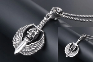 Detail of gothic punk skull pendant with sword and wings on a vintage box chain