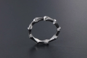 Detail view of titanium steel bone-shaped ring with vintage silver finish and punk style