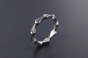 Close-up of gothic bone-shaped titanium steel ring with vintage silver finish