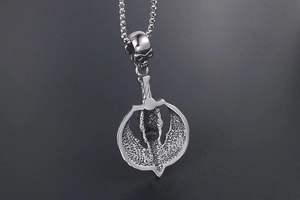 Close-up of punk skull pendant with hammered axe blade texture on steel chain