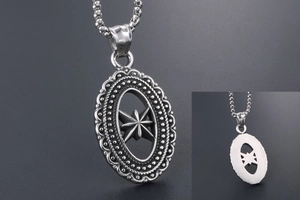 Macro detail of silver octagonal star pendant showing hollow design and embossed texture